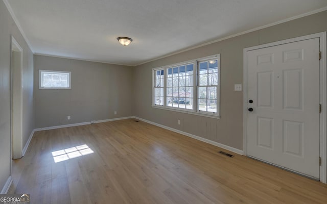 entryway with light hardwood / wood-style floors and ornamental molding