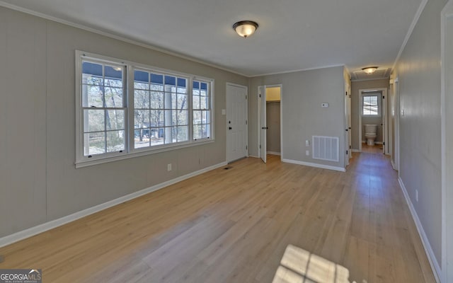 spare room with light hardwood / wood-style floors and ornamental molding