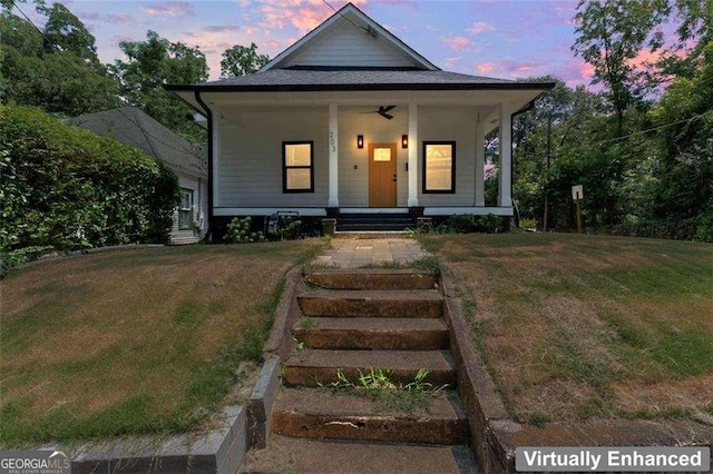 view of front facade featuring a lawn and a porch