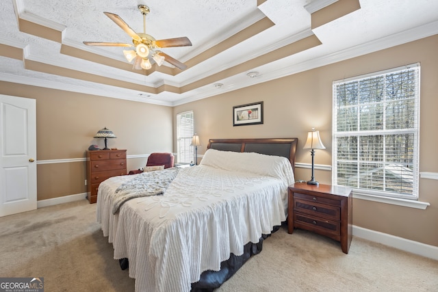 bedroom with a raised ceiling, ornamental molding, light colored carpet, and ceiling fan