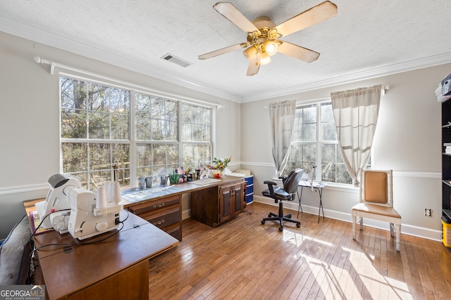 office area featuring ceiling fan, crown molding, a textured ceiling, and light hardwood / wood-style floors