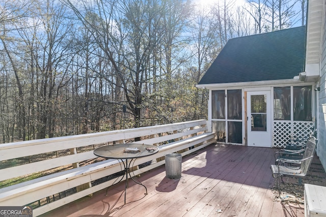 wooden deck with a sunroom