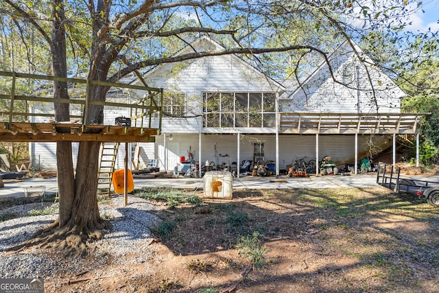 back of property featuring a patio area and a sunroom