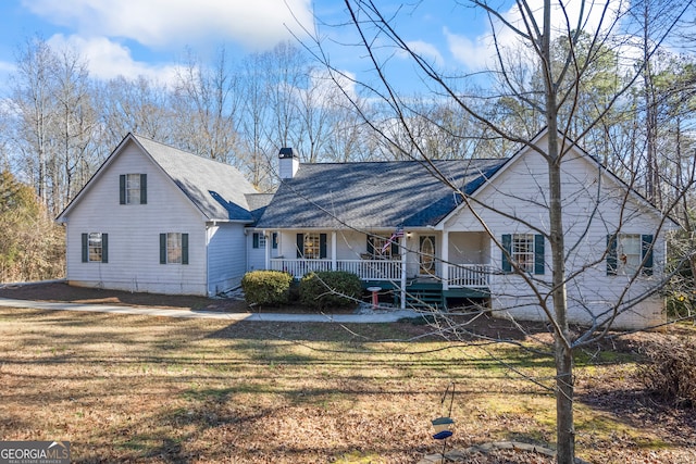 rear view of property with a lawn and a porch