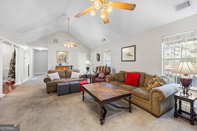 living room featuring decorative columns, ceiling fan, light colored carpet, and high vaulted ceiling