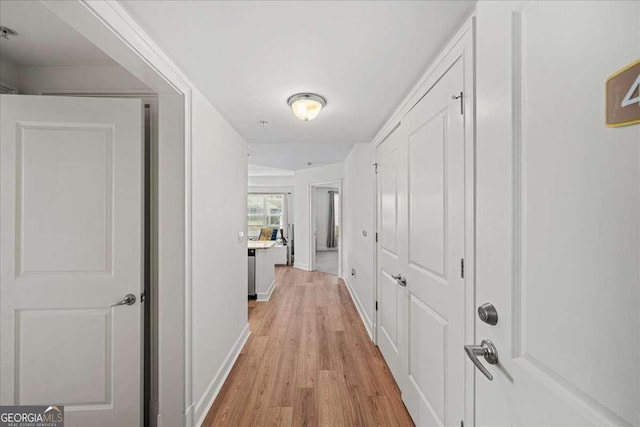 corridor with light hardwood / wood-style flooring