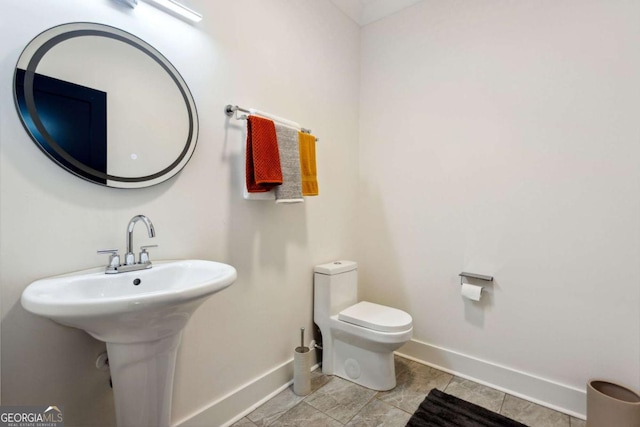 bathroom featuring tile patterned flooring and toilet