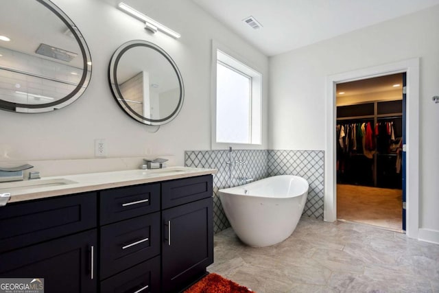 bathroom featuring a tub and vanity