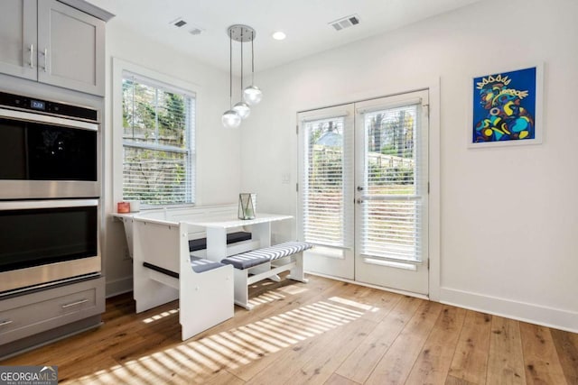 dining room featuring french doors and light hardwood / wood-style floors