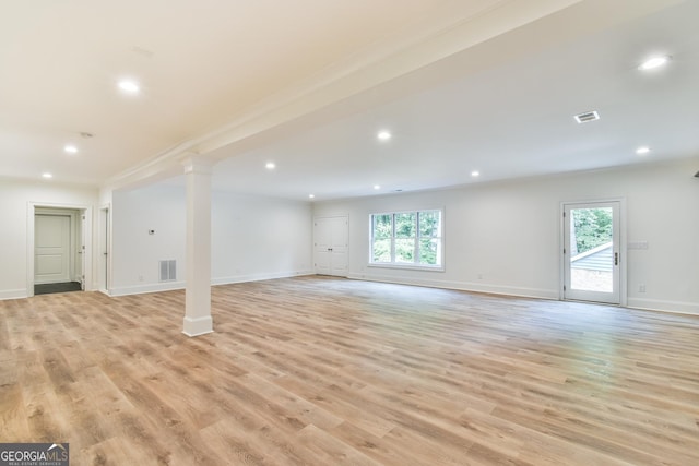 interior space featuring a healthy amount of sunlight, light hardwood / wood-style flooring, and ornamental molding