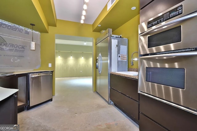 kitchen with pendant lighting, stainless steel appliances, and sink