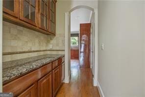 interior space featuring stone countertops and light hardwood / wood-style flooring