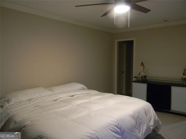 carpeted bedroom featuring ceiling fan and ornamental molding