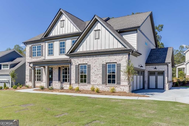 view of front of home featuring a porch, a garage, and a front lawn