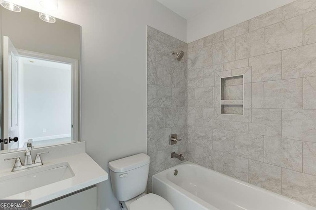 full bathroom with vanity, toilet, and tiled shower / bath