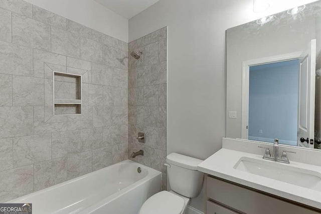 full bathroom with vanity, toilet, and tiled shower / bath