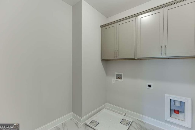 laundry room featuring hookup for an electric dryer, hookup for a washing machine, and cabinets