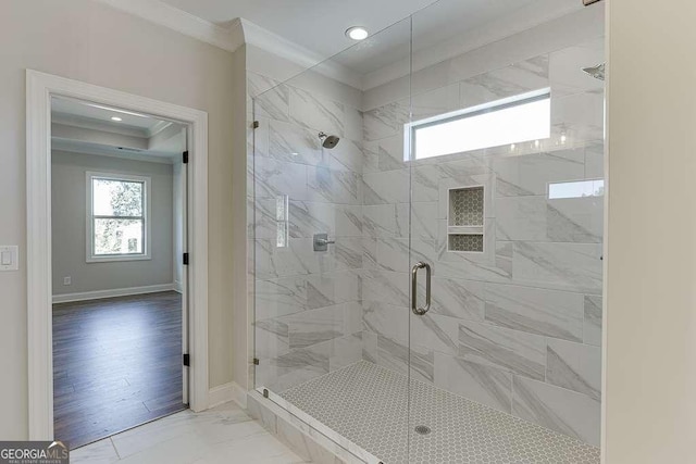 bathroom with an enclosed shower and ornamental molding