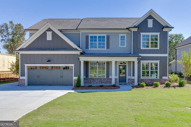 craftsman inspired home with a front yard, a garage, and covered porch