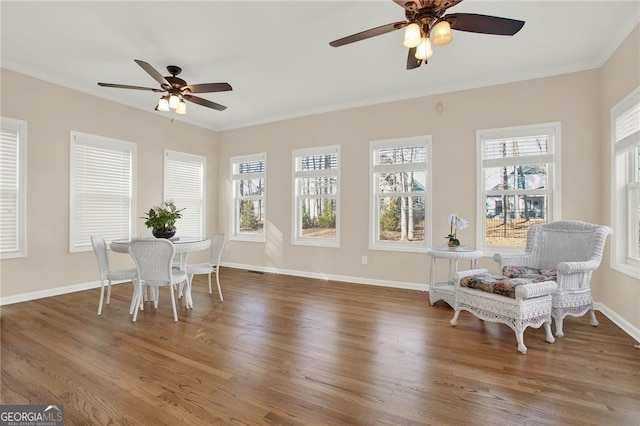 sunroom featuring ceiling fan