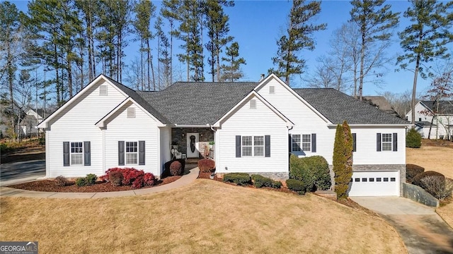 ranch-style home with a garage and a front yard