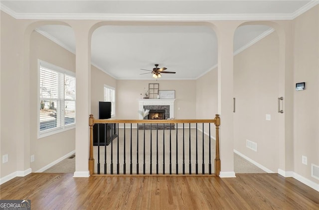 hallway with hardwood / wood-style floors and crown molding