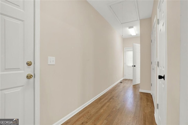 hallway with lofted ceiling and light wood-type flooring