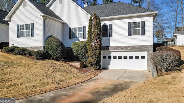 view of front of home with a front yard and a garage