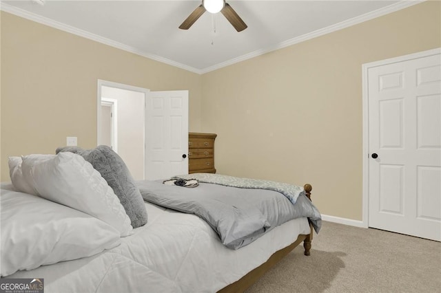 carpeted bedroom featuring ceiling fan and crown molding