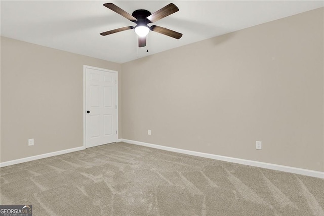 carpeted empty room featuring ceiling fan