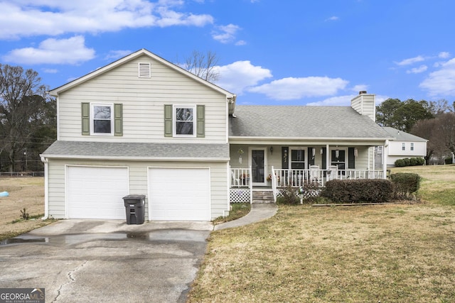 split level home with a porch, a garage, and a front lawn