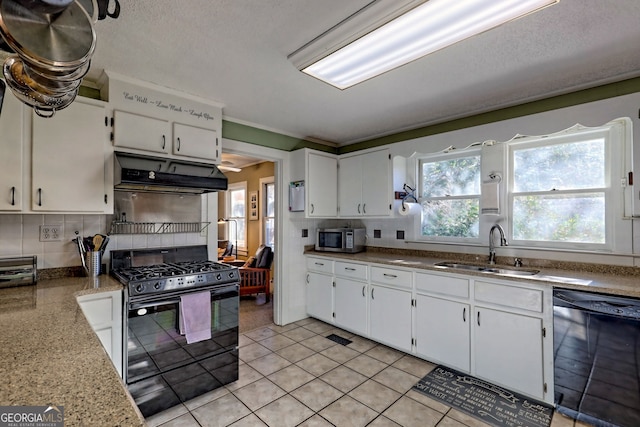 kitchen with white cabinets, light tile patterned floors, sink, and black appliances