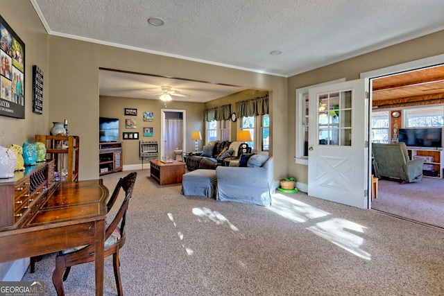 carpeted living room featuring a wealth of natural light, ceiling fan, and a textured ceiling