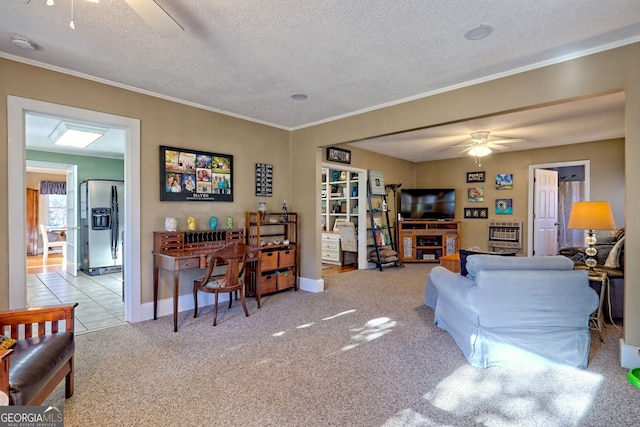 living room with a textured ceiling, light colored carpet, heating unit, ceiling fan, and crown molding