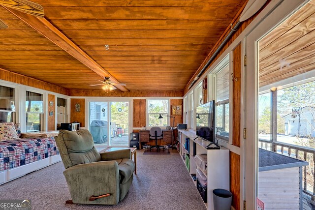 sunroom / solarium with ceiling fan, beamed ceiling, and wooden ceiling