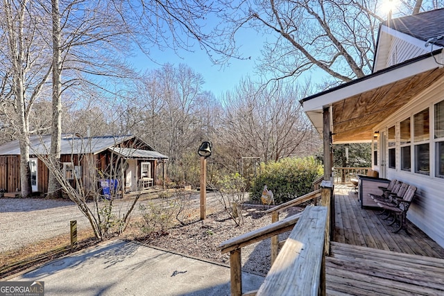 view of yard with a deck and an outdoor structure