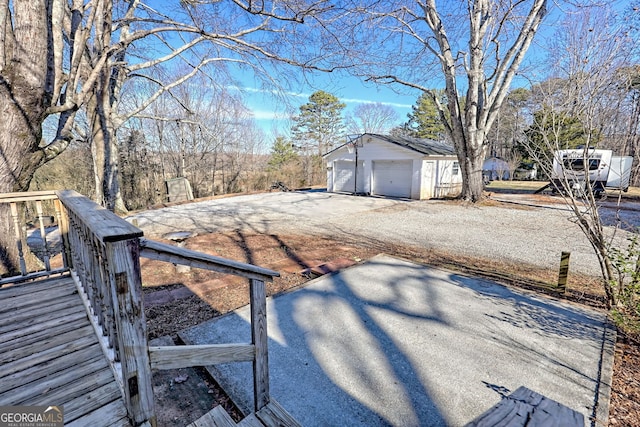 view of yard with a garage and an outbuilding