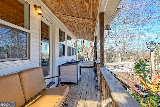 wooden terrace with a porch