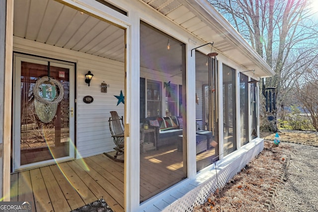 view of exterior entry with a wooden deck