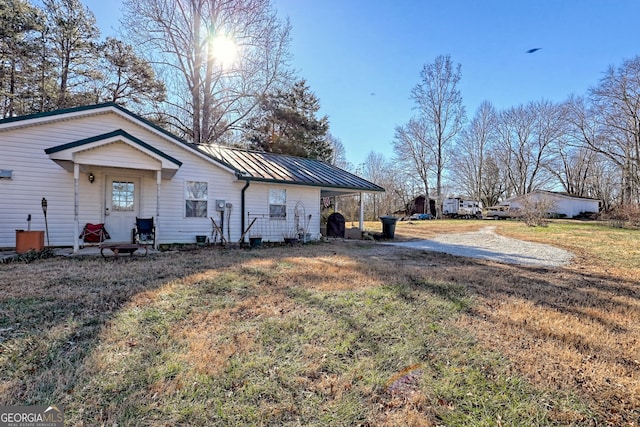 exterior space featuring a lawn and a carport