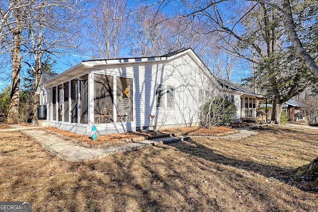 view of property exterior with a sunroom