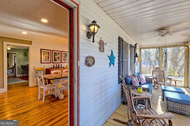 sunroom / solarium featuring ceiling fan