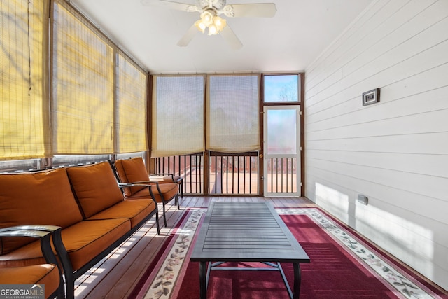 sunroom / solarium featuring ceiling fan