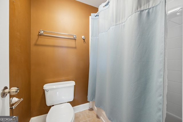 bathroom with tile patterned floors, a shower with curtain, and toilet