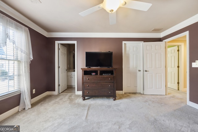 bedroom featuring ensuite bath, ceiling fan, light colored carpet, and multiple windows