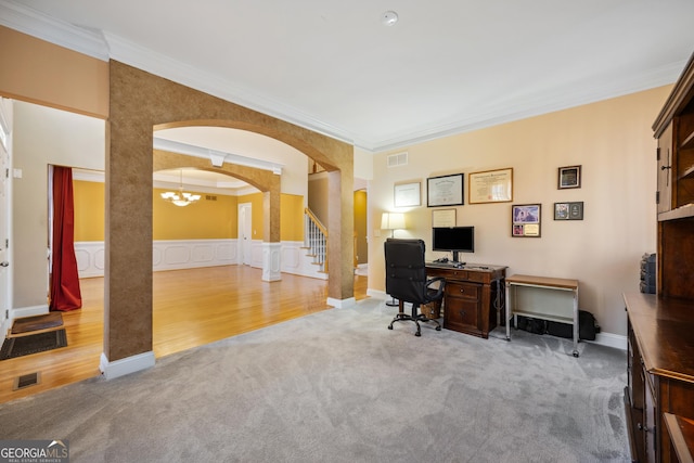 home office with carpet, ornamental molding, and an inviting chandelier