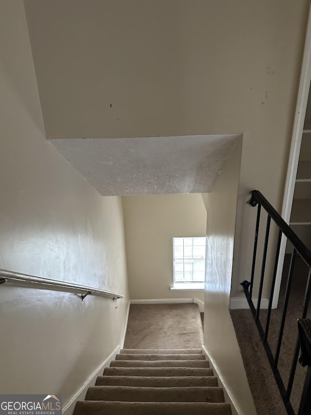 stairs with carpet flooring and baseboards