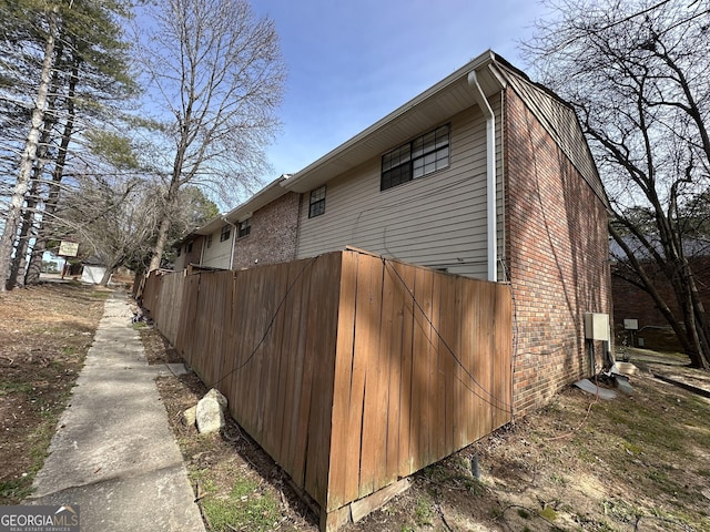 view of side of property with brick siding