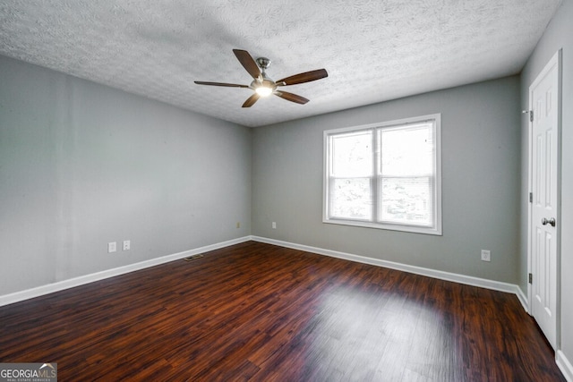 spare room featuring ceiling fan, dark hardwood / wood-style flooring, and a textured ceiling