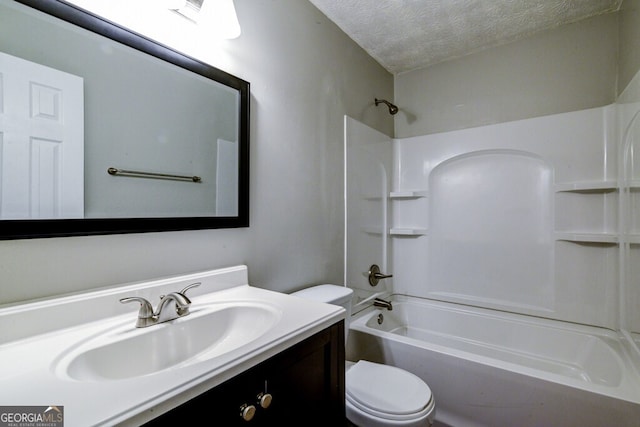 full bathroom with shower / bathing tub combination, vanity, toilet, and a textured ceiling